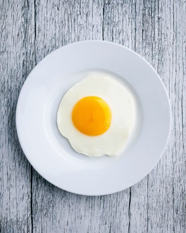 fake egg made of peach half on plate