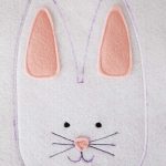 stitching around the outline of the bunny head from to top of one ear down and around the face to the top of the other ear; leaving the inside of the ears unstitched