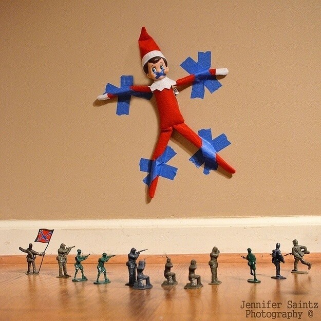 Elf stuck to wall in front of a miniature firing squad 