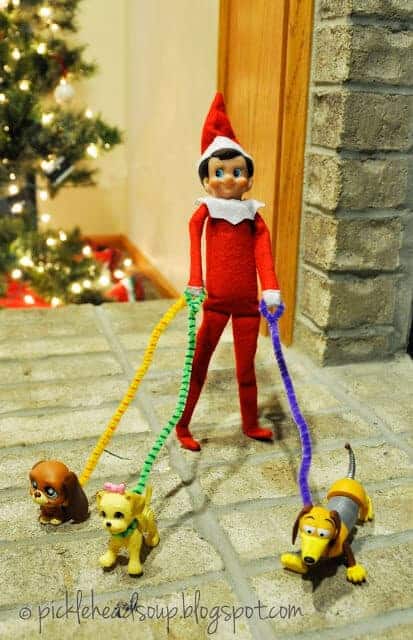 Elf walking dogs with pipe cleaners used as leashes 