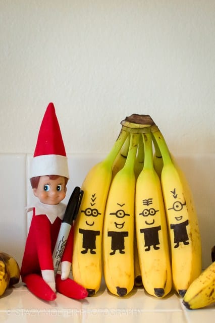 elf decorating bananas like minions with black sharpie