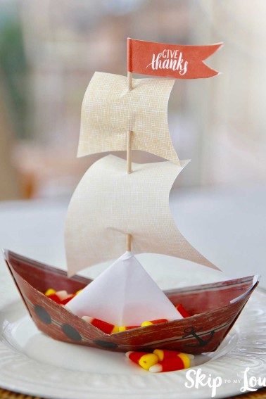 paper mayflower ship sitting on white plate