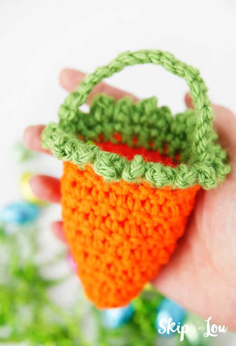 hand holding crochet carrot basket
