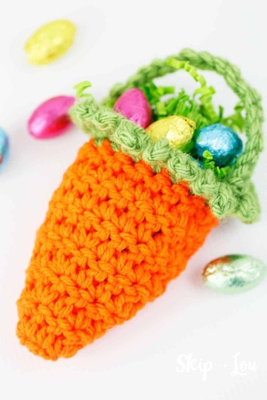 crochet carrot basket filled with chocolate eggs