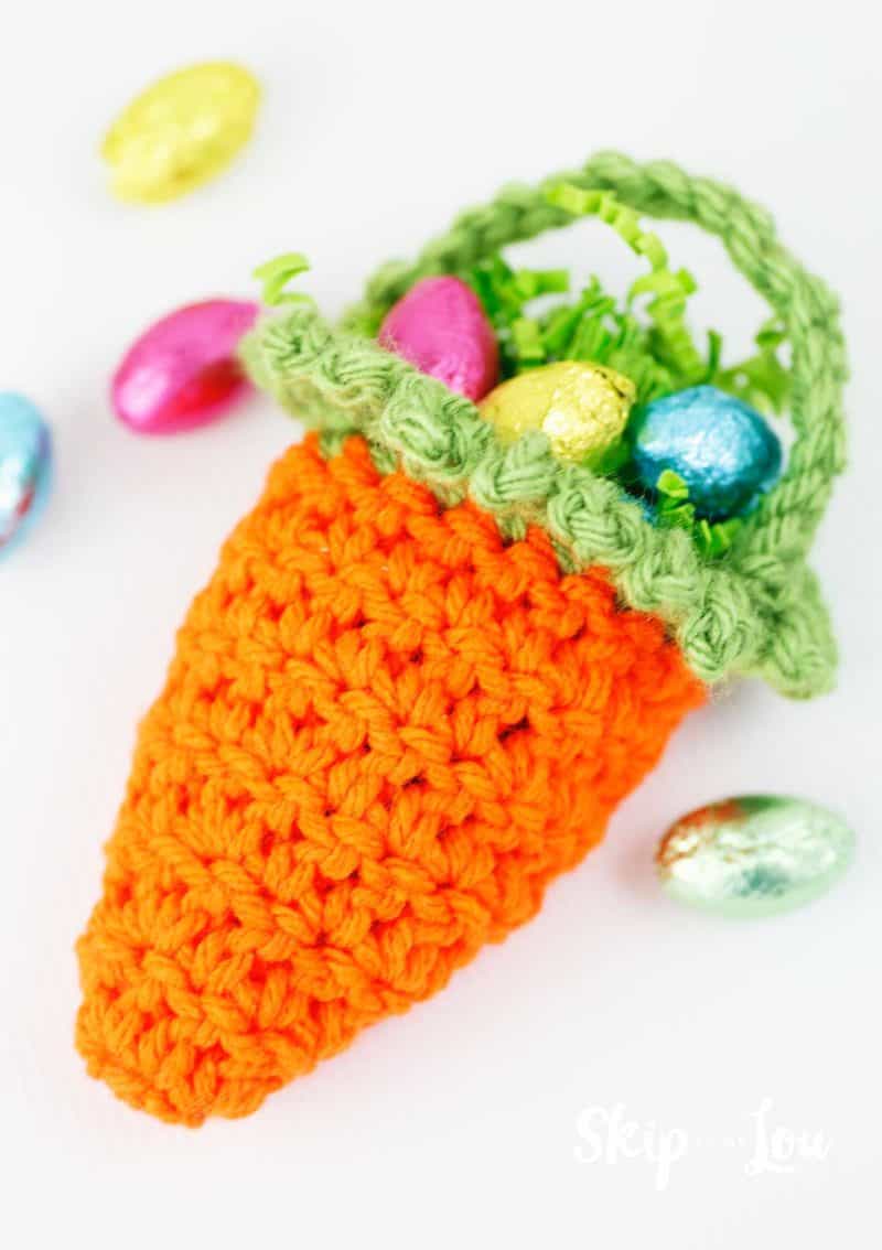 crochet carrot basket filled with chocolate eggs