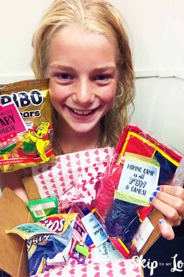 kid holding camp care package