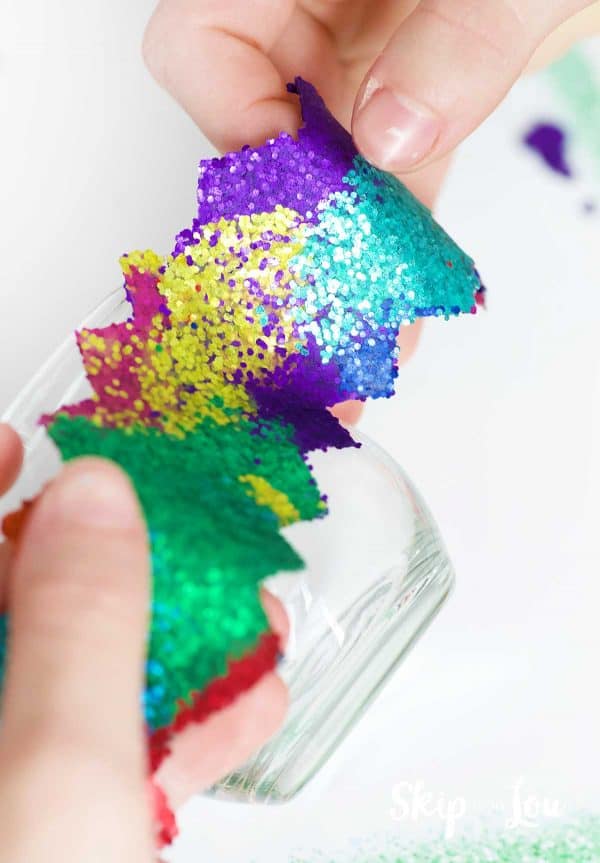 placing rolled strip of glitter dot on side of glass votive