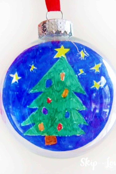 round glass ornament with childs artwork of christmas tree