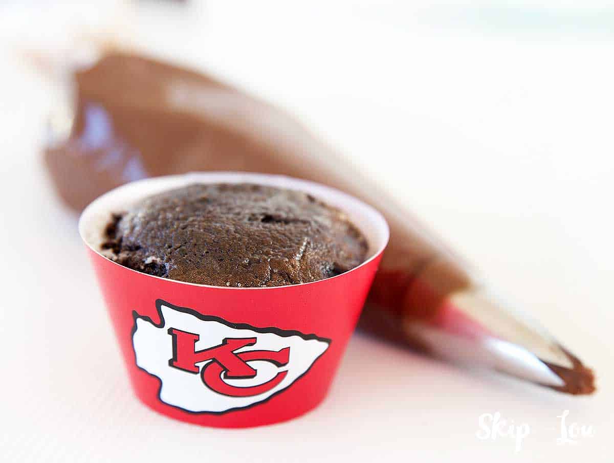 unfrosted chiefs cupcake pastry bag with chocolate frosting