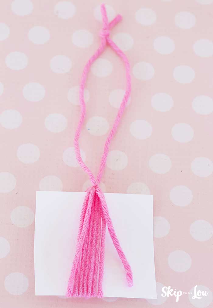 knot tied at top of yarn wrapped card