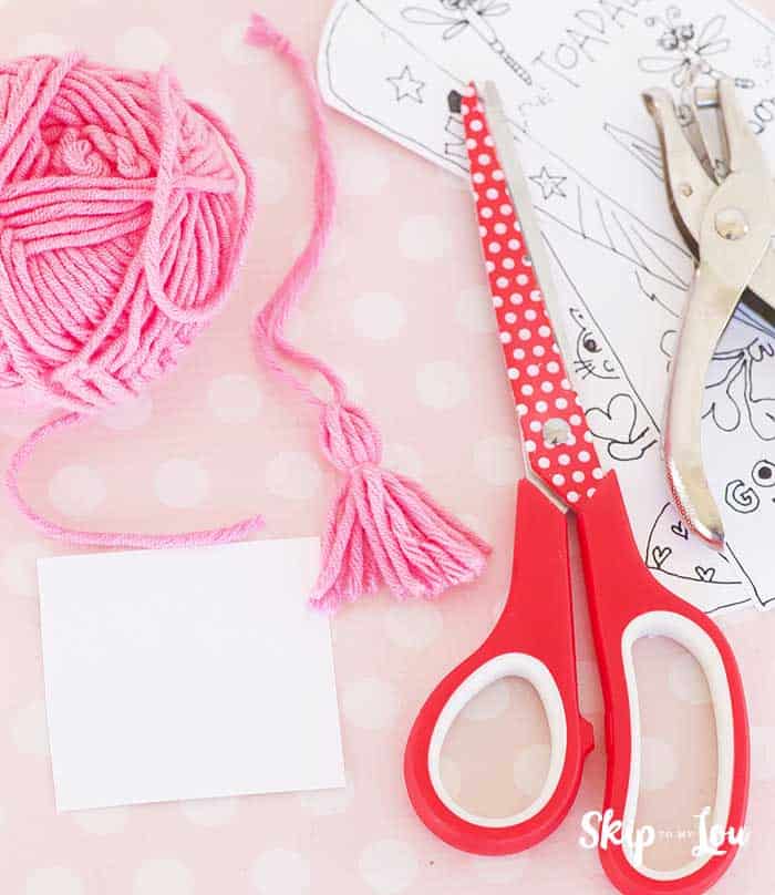 scissors hole punch yarn to make tassel for book mark