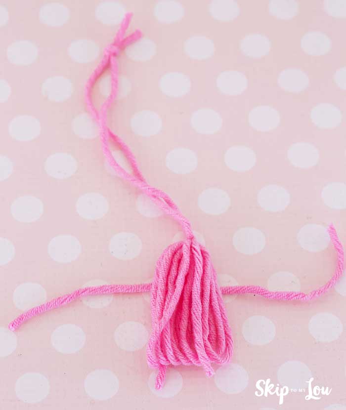 wrap piece of yarn around tassel