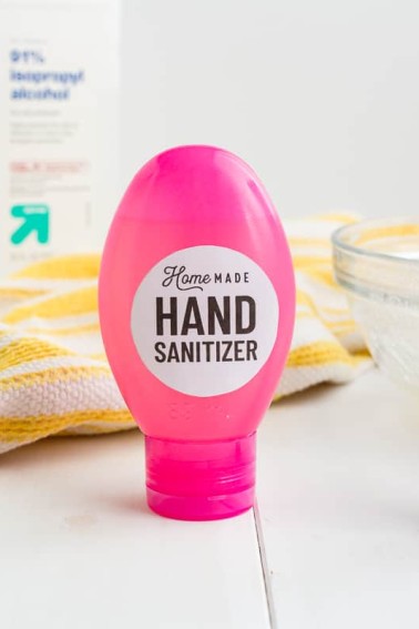homemade hand sanitizer in pink bottle with white circle label