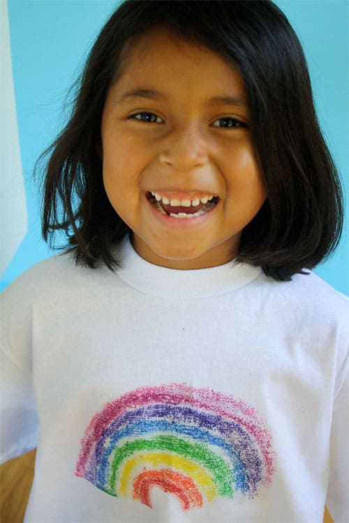 child wearing rainbow sandprint shirt