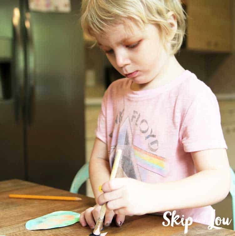 child painting paper egg shape