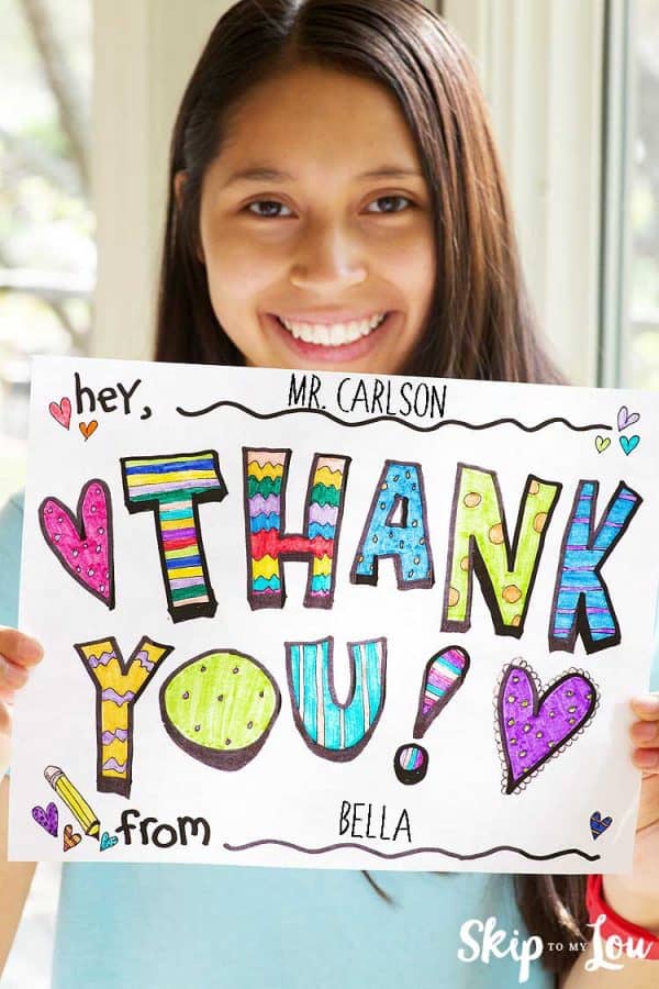girl holding colored thank you coloring page sign