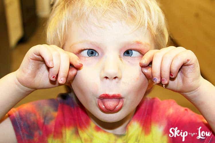 child wearing make up making silly face