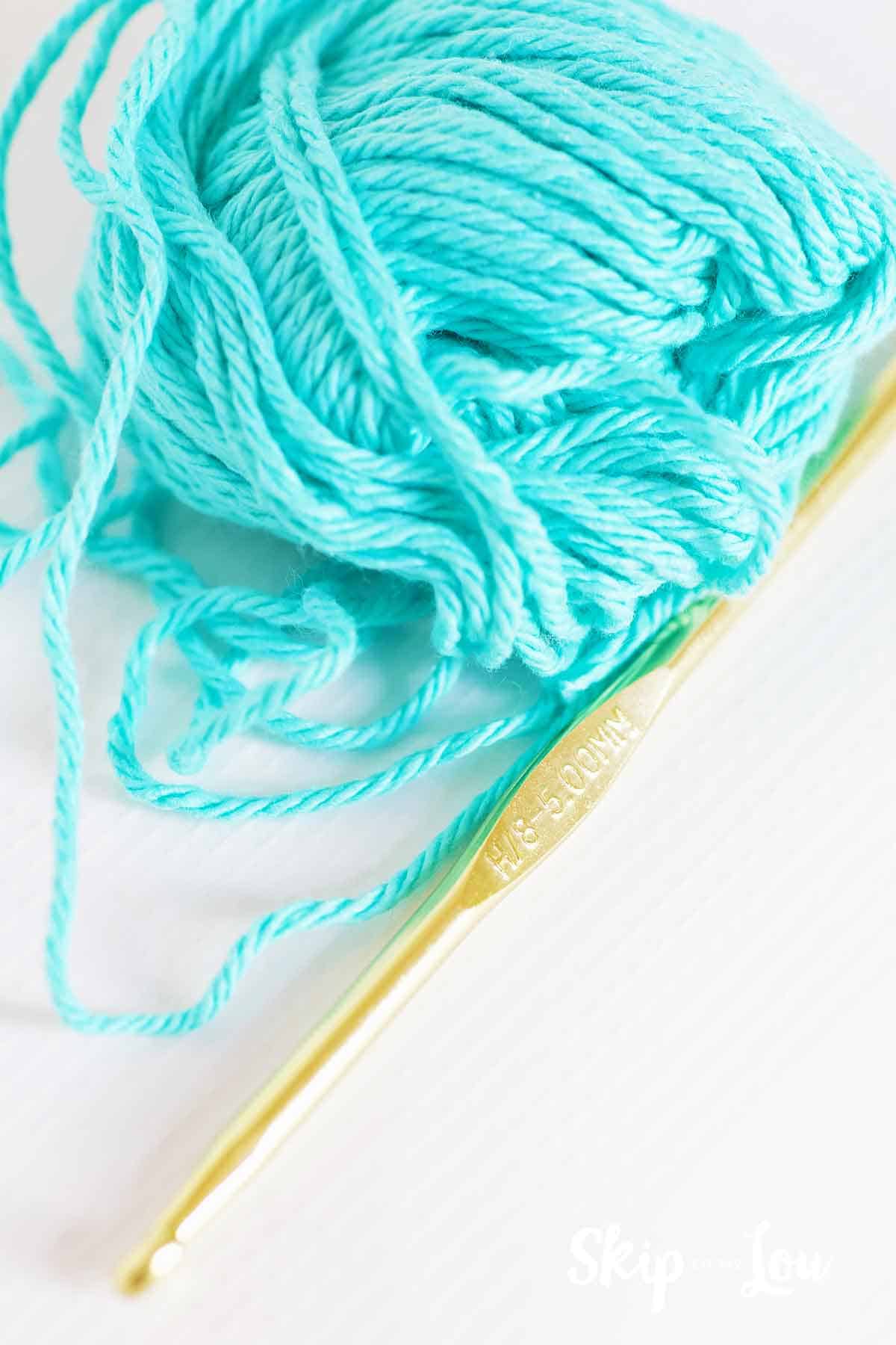 cotton yarn next to H crochet hook