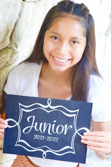 child holding sign for first day of school