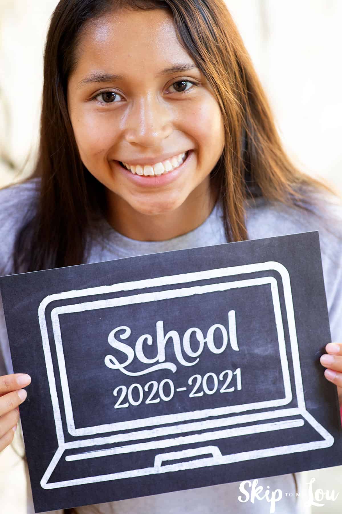 virtual learning back to school sign girl holding
