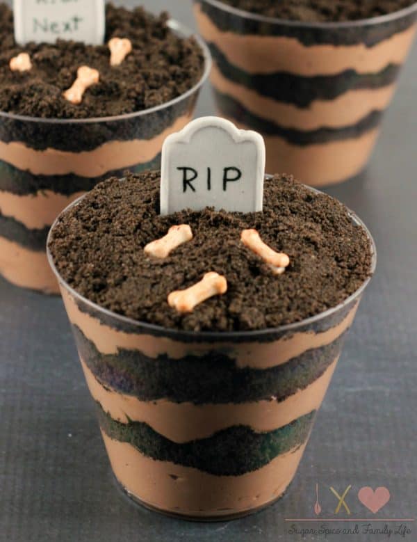Image shows three dirt cake cups decorated for Halloween, they look like a graveyard