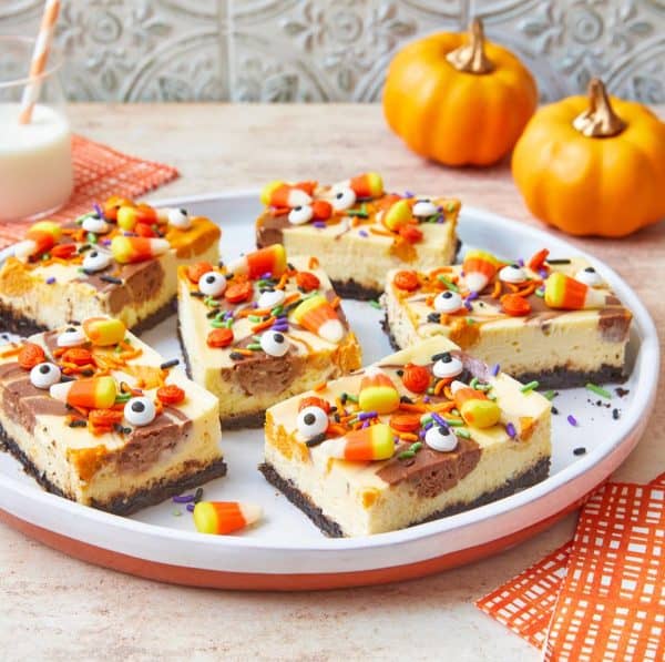Image shows cheesecake bars decorated for Halloween