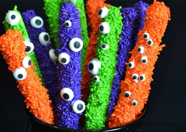 Image shows a batch of colored pretzels decorated for Halloween