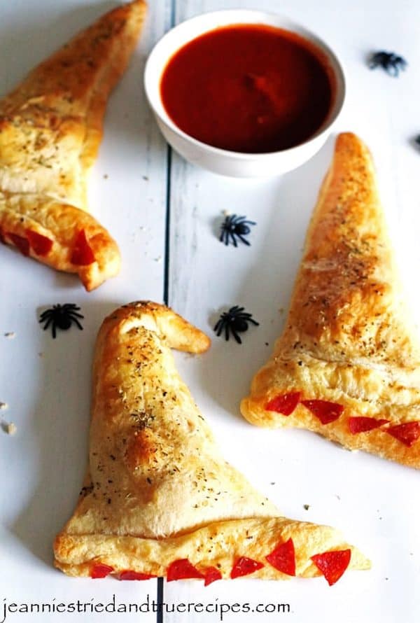 Image shows three calzones shaped like witch hats.