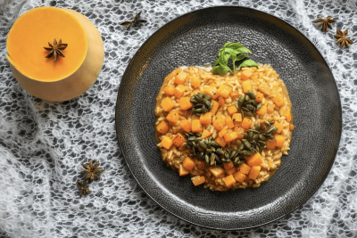 Image shows a risotto dish shaped and decorated to look like a pumpkin.