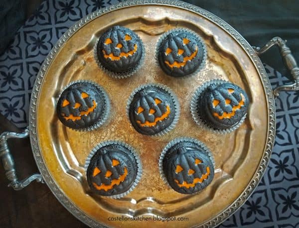 Image shows chocolate cupcakes that look like jack-o-lantern.