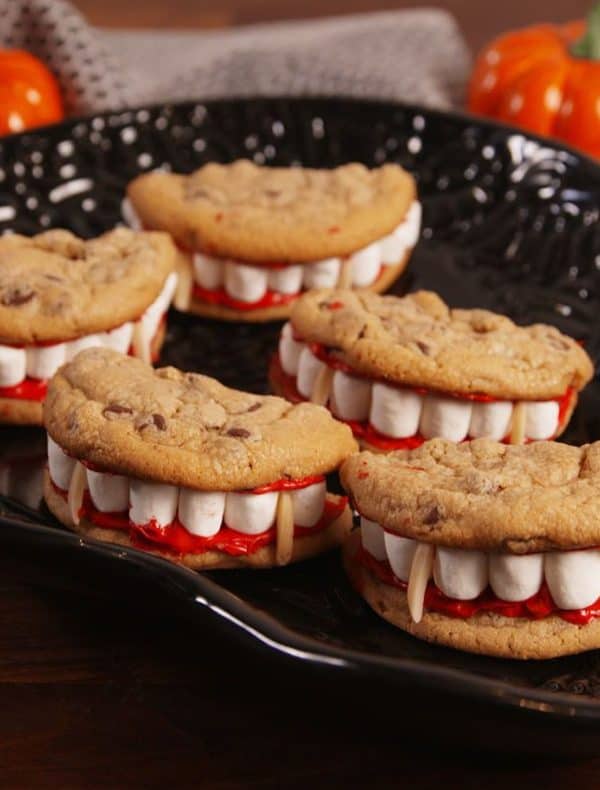 Image shows a batch of cookies decorated to look like vampire teeth.