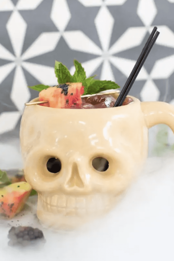 Image shows a skull-shaped mug with a Halloween cocktail in it