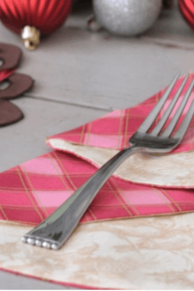christmas tree napkin next to white plate