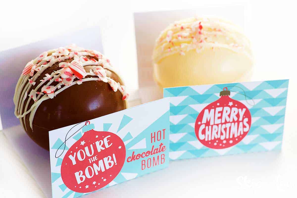 cocoa bombs sitting in folded printable before wrapping in cellophane bag
