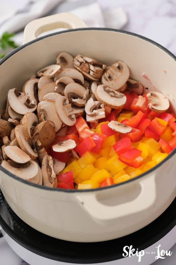 chopped red and yellow bell pepper and sliced mushrooms add to the browned chicken for the weight loss soup