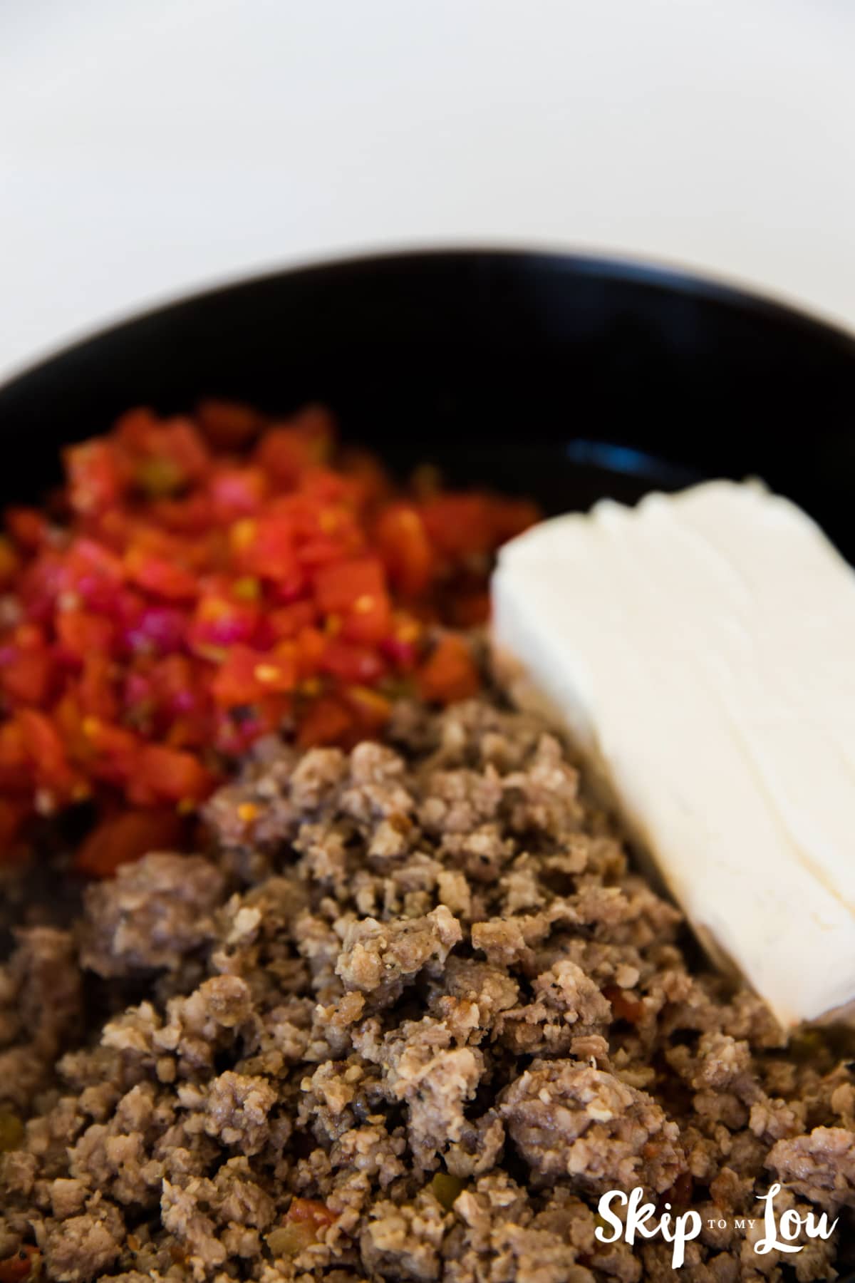 rotel sausage cream cheese in black skillet