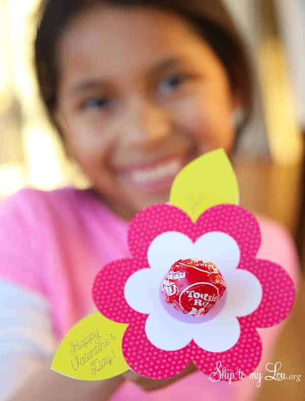 lollipop flower valentine - pink and white flower with a lollipop pushed the the center; with light green leaves and a happy valentine's message printed on the leaves