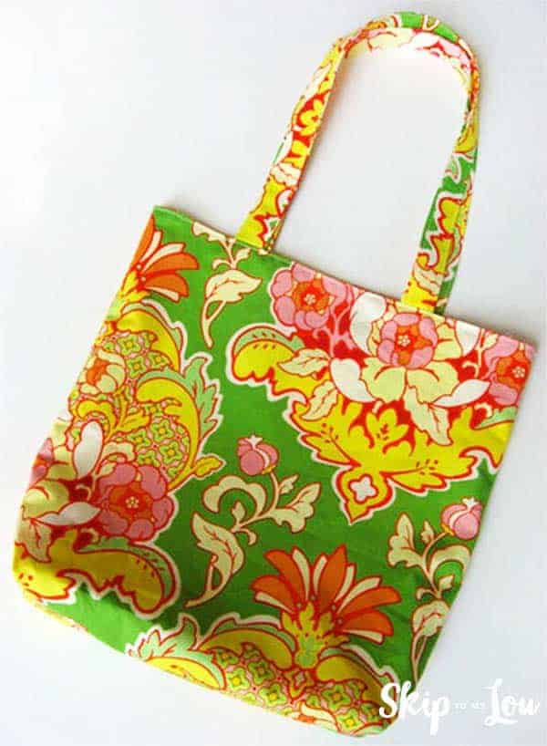 gift idea floral patterned reversible tote, the fabric is vibrant green, yellow, red, and pink
