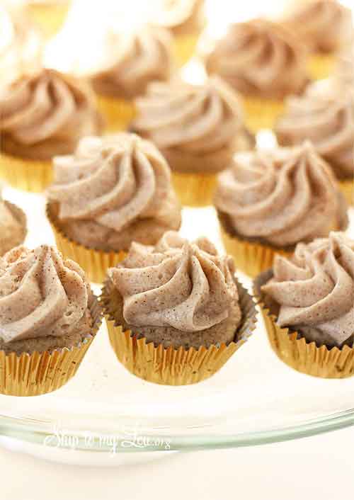 snickerdoodle cupcakes on a clear glass platter