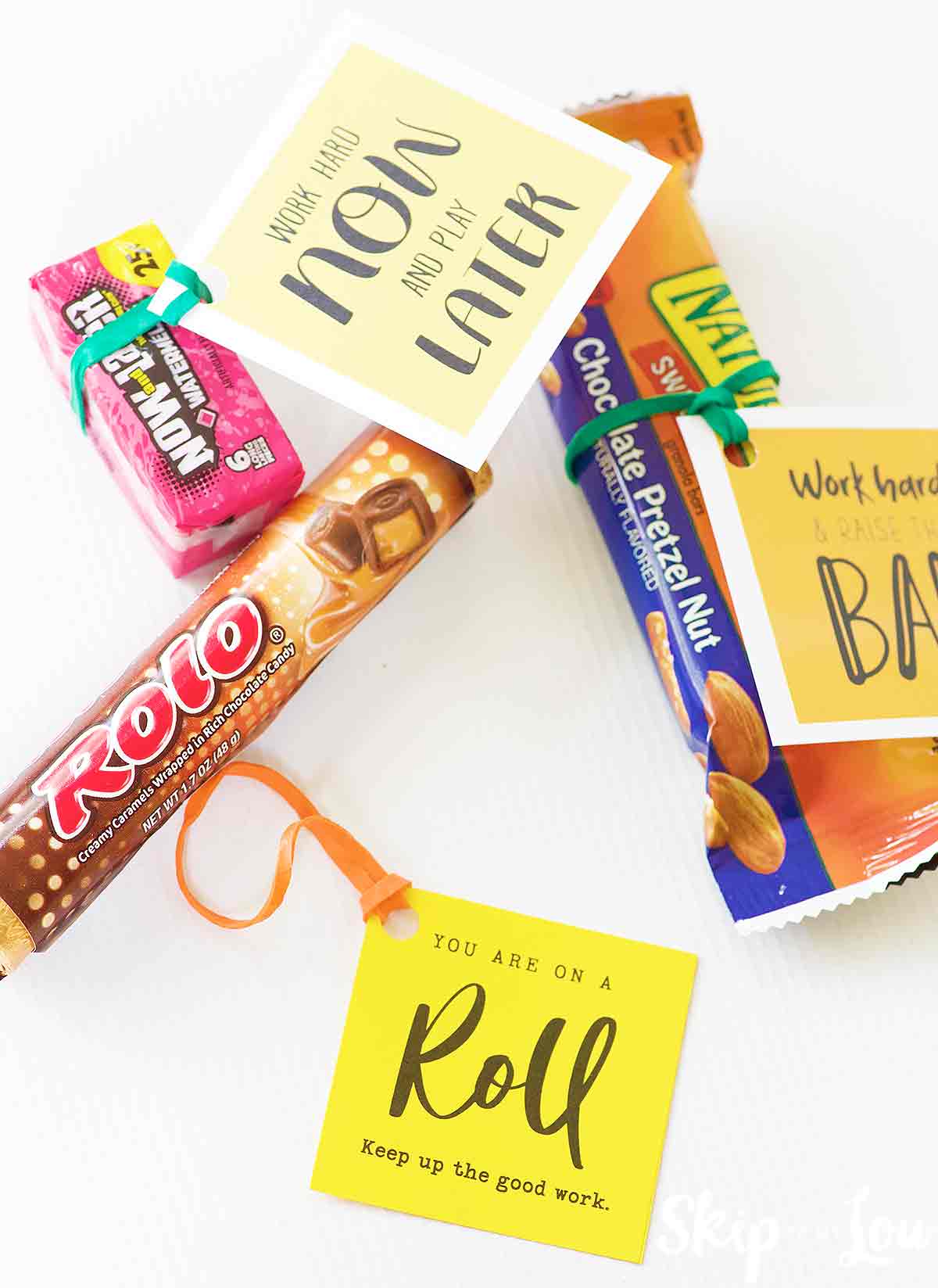 small gift tags attached to gifts with rubber bands