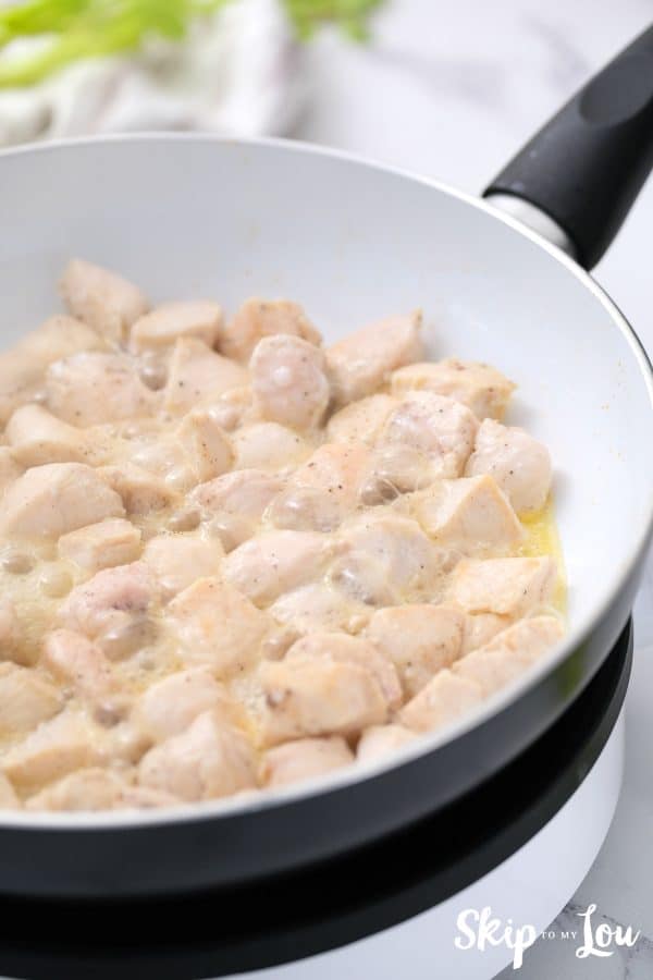 Chicken placed in cooked onion and cream mixture for the chicken pot pie. -Skip To My Lou