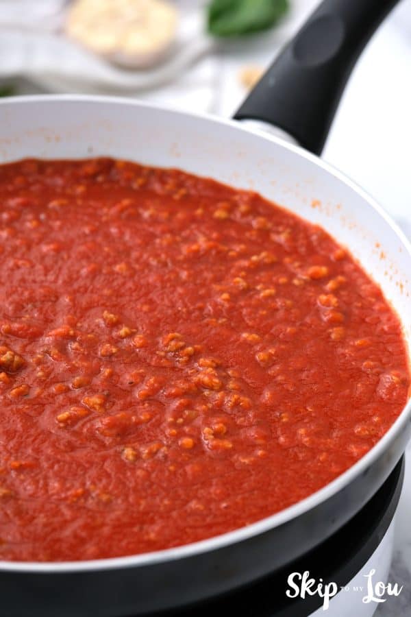 skillet of marinara with sausage sauce for the gluten free dairy free lasagna
