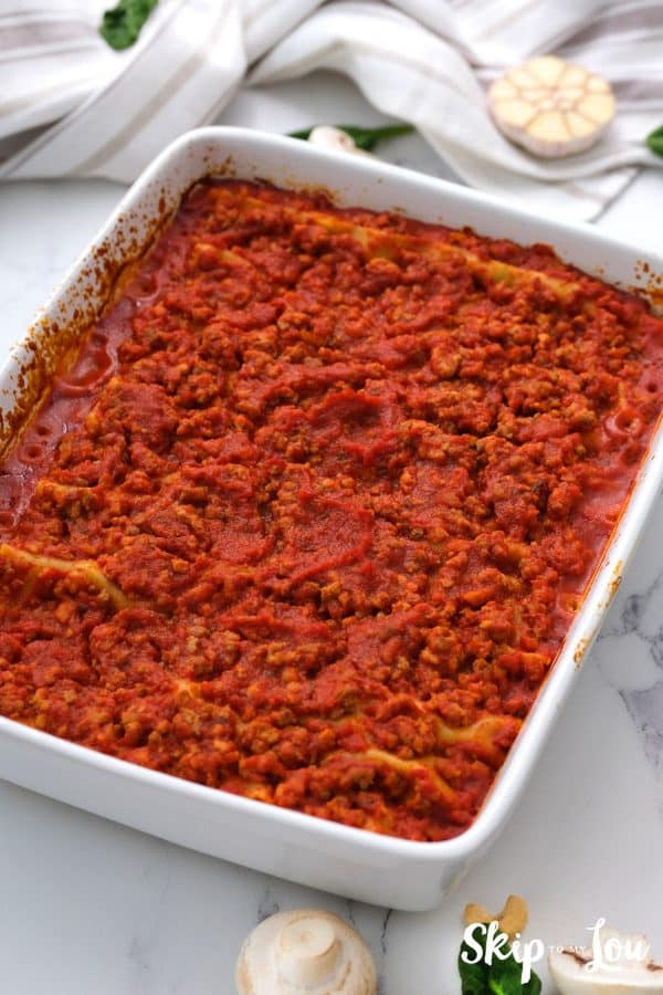 a white casserole dish of baked gluten free dairy free lasagna all ready to serve