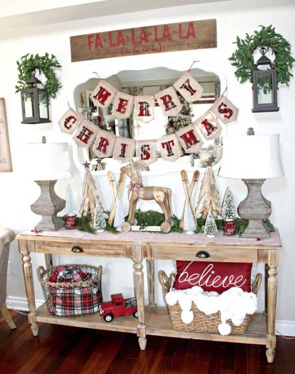 Image shows a Christmas entry way table display with the words Merry Christmas.