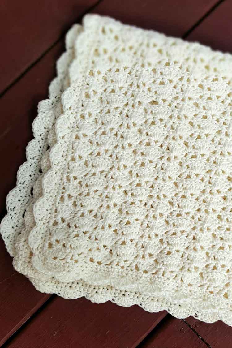 white lacy blanket with shell border