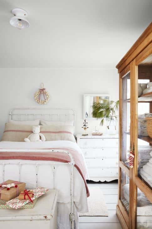 Image shows some holiday blankets in a white bedroom.