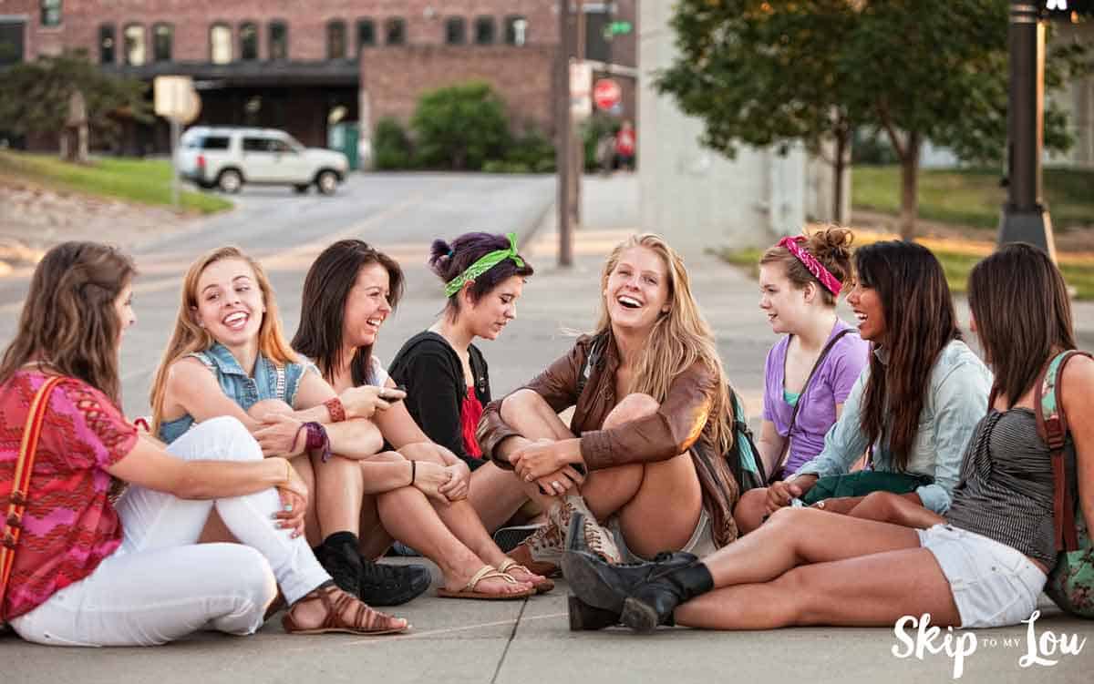 Teens laughing as they play Never Have I Ever