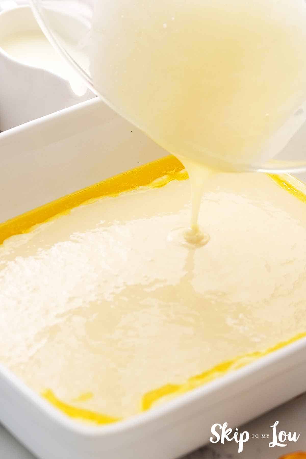 batter poured over melted butter in white 9 x 13 pan