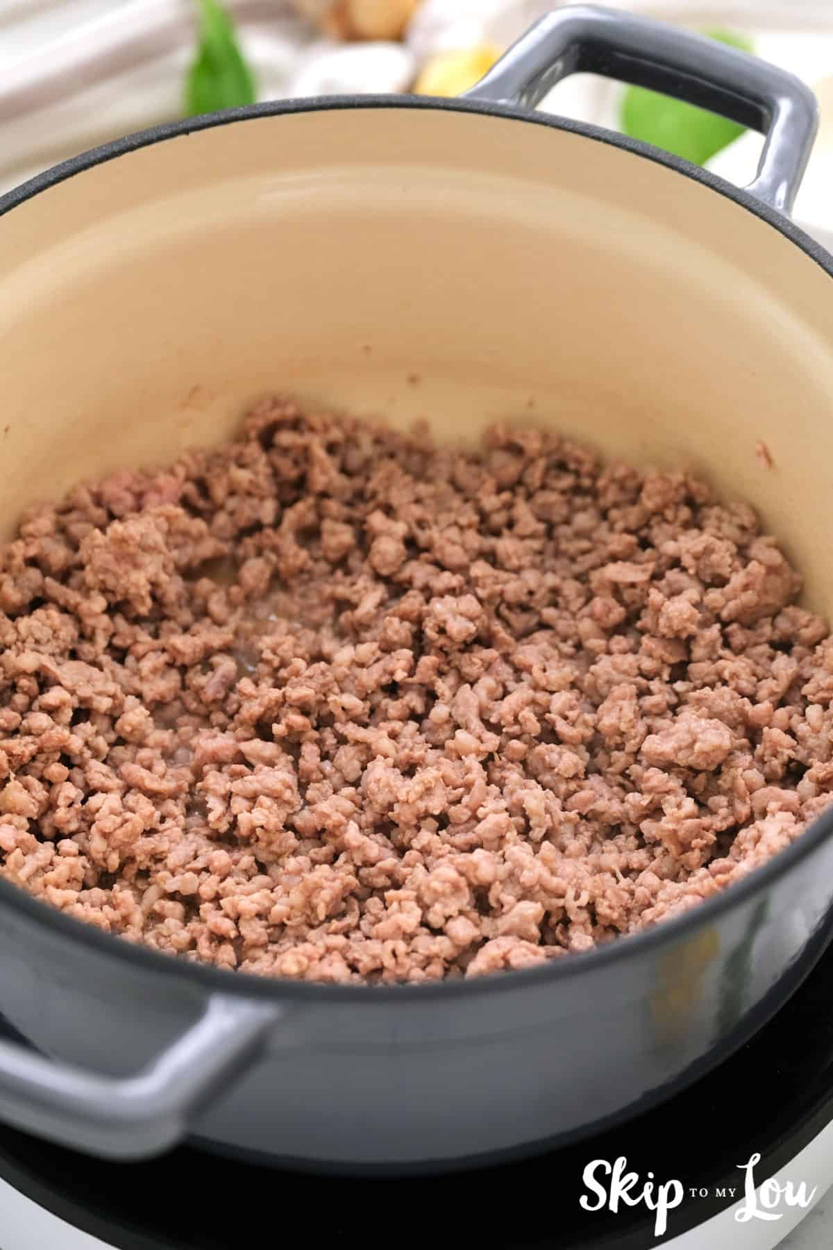 browned sausage in a pot to make sausage tortellini soup