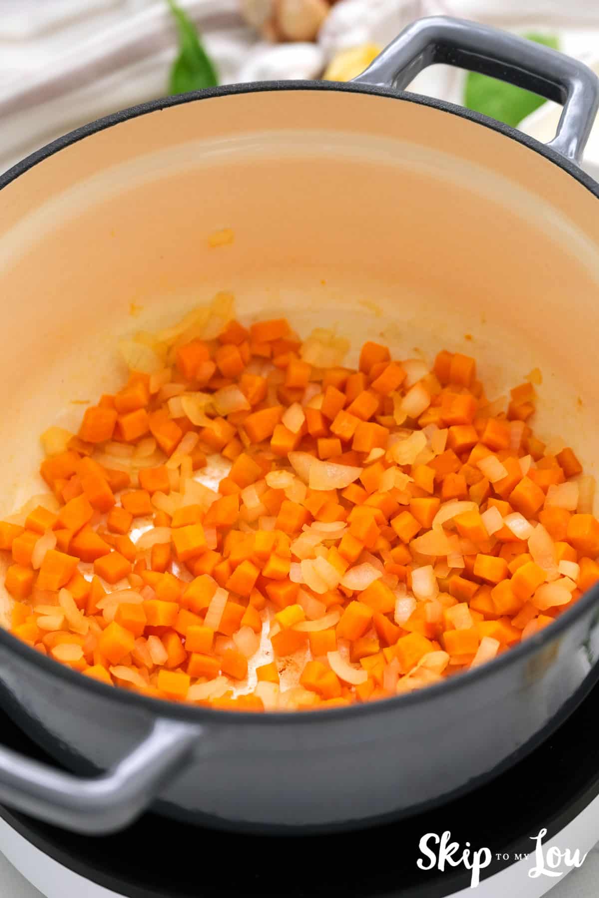 saute onions and carrots to make soup